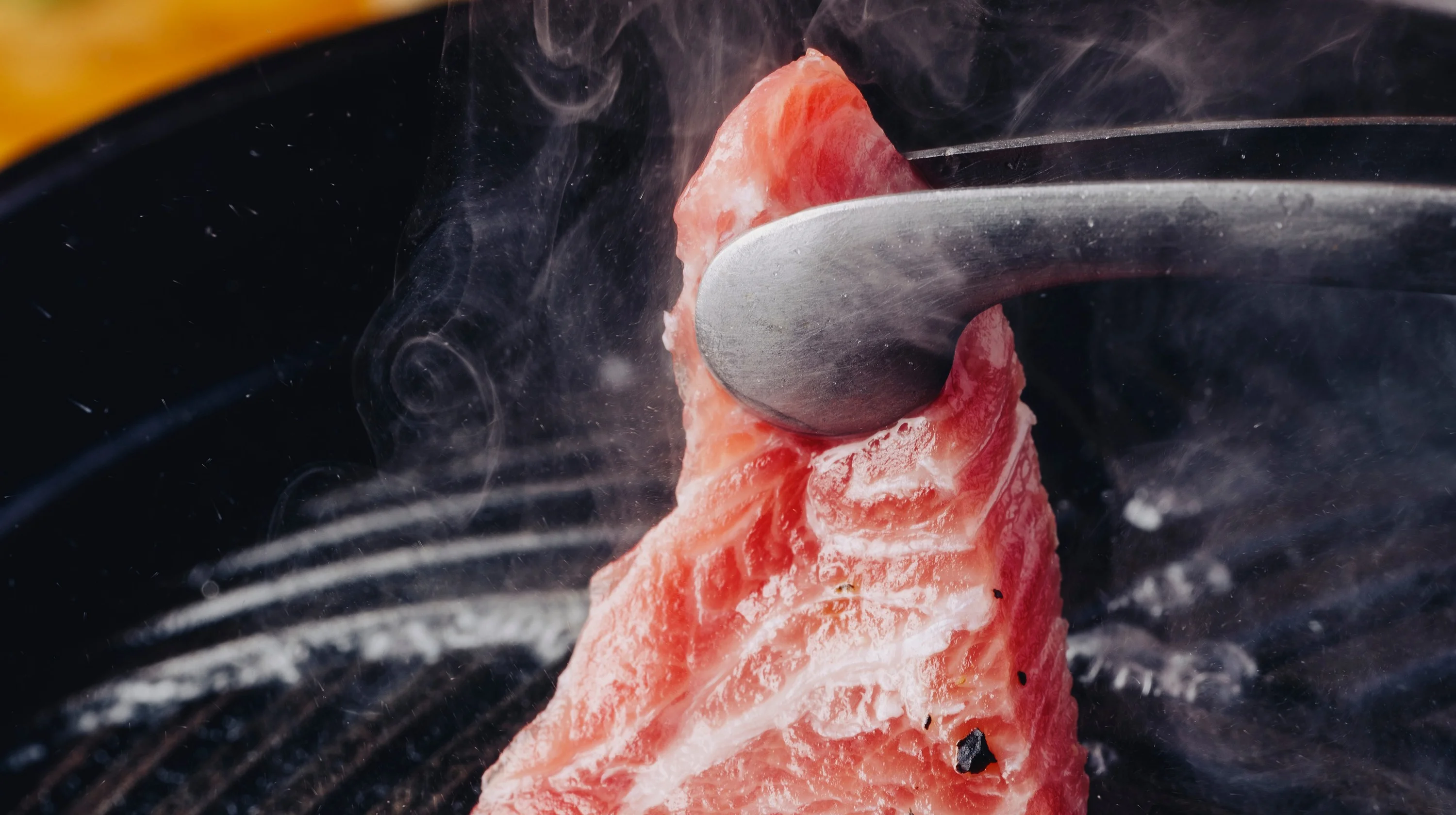 Steam rising from char-grilled bluefin tuna
