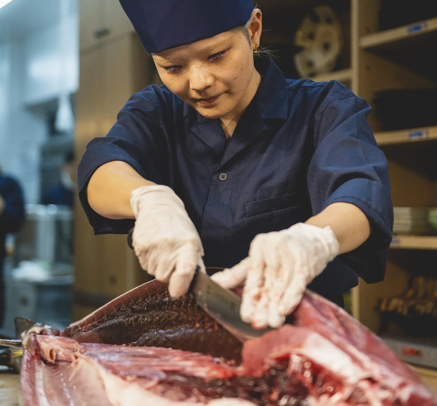 Chef breaking down fresh wild tuna during the cutting show