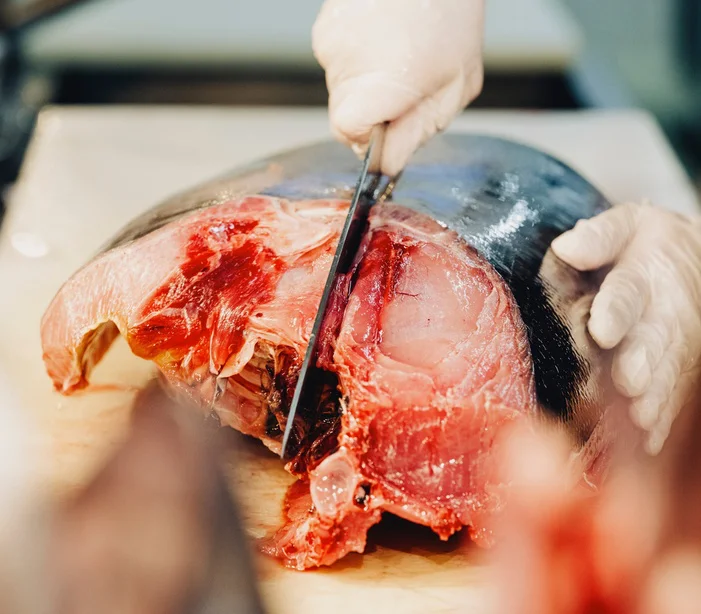 Cutting show boldly carving up a tuna head
